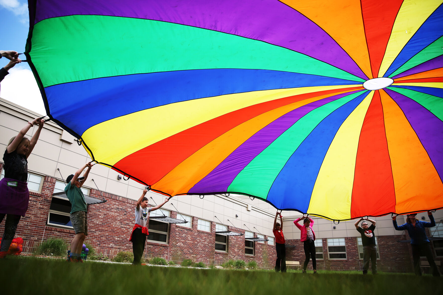 The rainbow circle tent is thrown up in the air by students